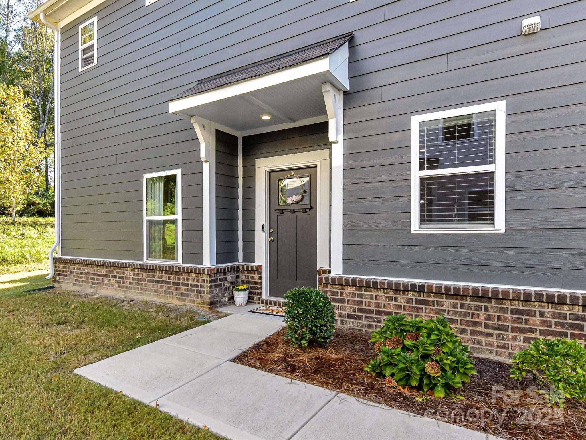230 Quinn Road Matthews, NC 28104 - Photo 3 of 35 a front view of a house with a yard