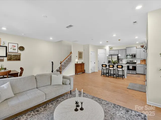 a living room with furniture and kitchen view