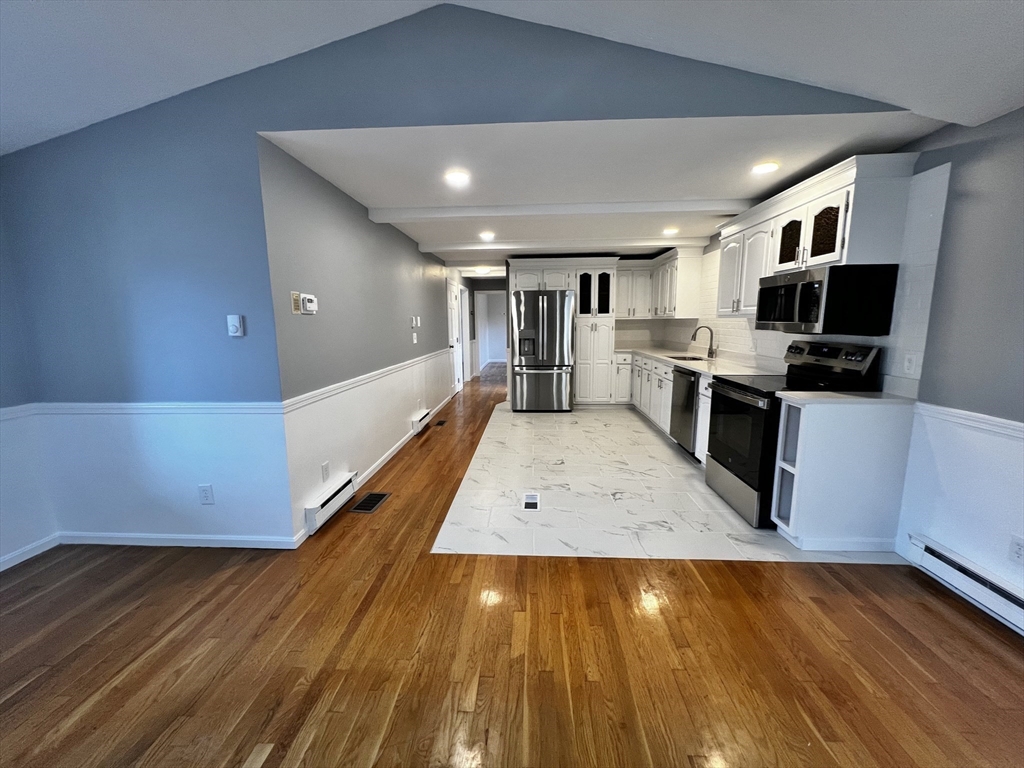 6 Mayfield Road Auburn, MA 01501 - Photo 12 of 30 a living room with stainless steel appliances furniture and flat screen tv