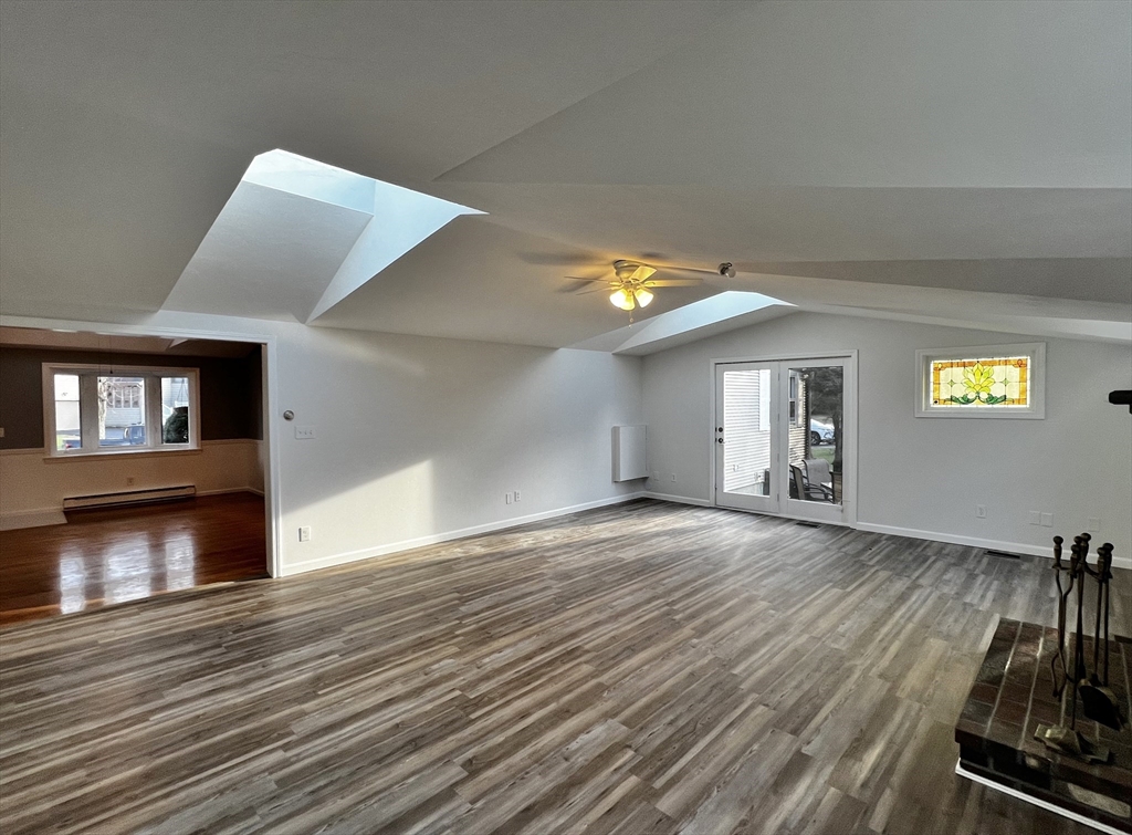 6 Mayfield Road Auburn, MA 01501 - Photo 17 of 30 a view of empty room with wooden floor and fireplace