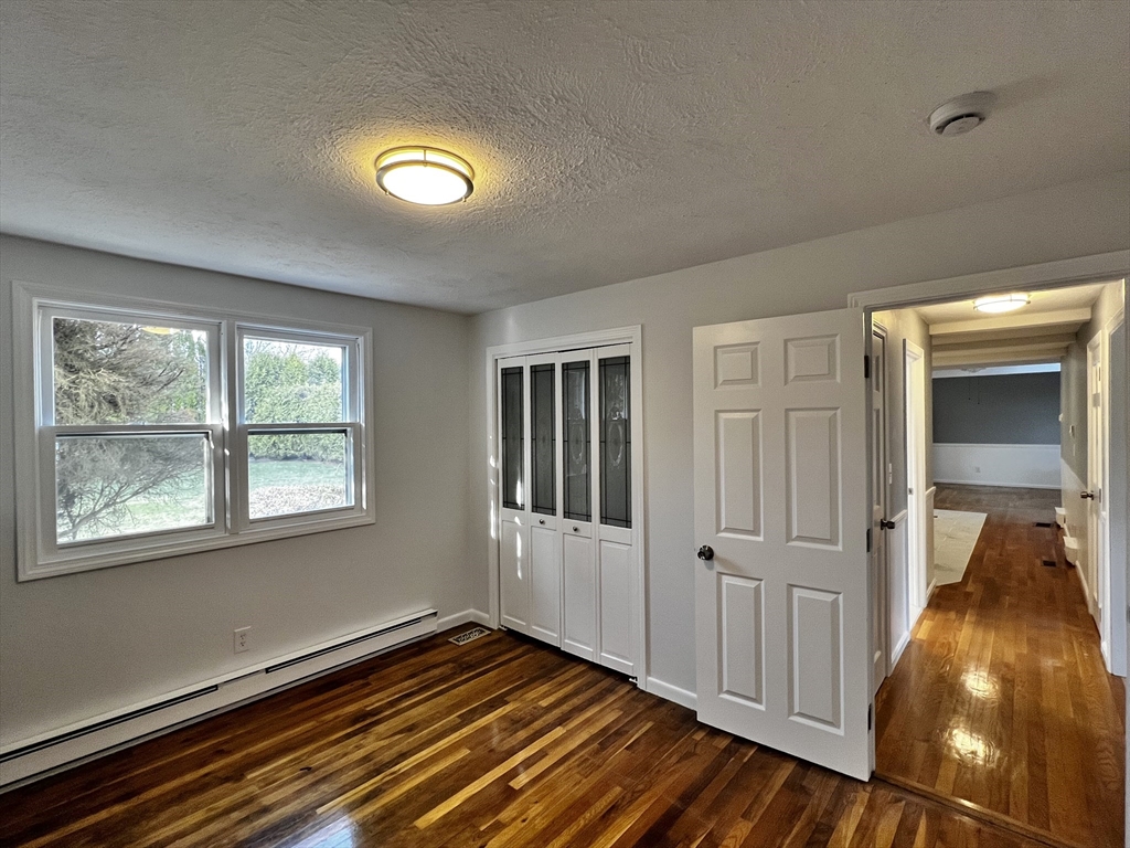 6 Mayfield Road Auburn, MA 01501 - Photo 22 of 30 a view of an empty room with wooden floor and a window