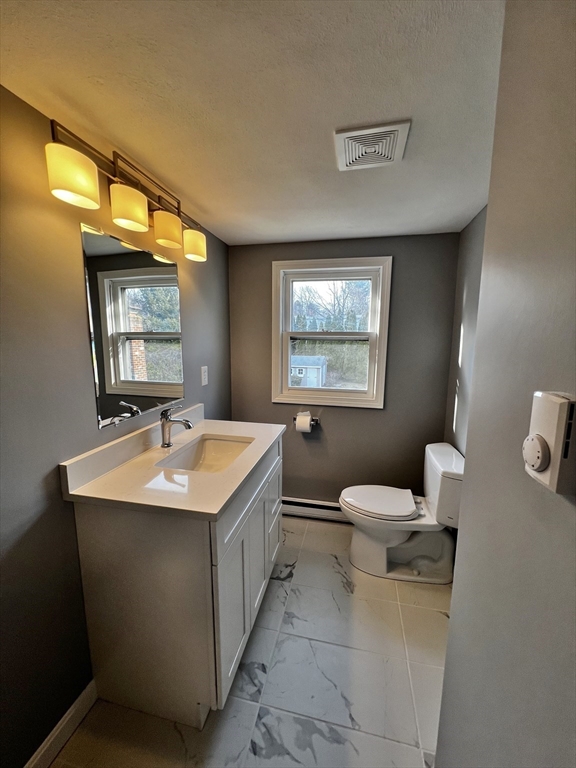 6 Mayfield Road Auburn, MA 01501 - Photo 28 of 30 a bathroom with a toilet sink and mirror