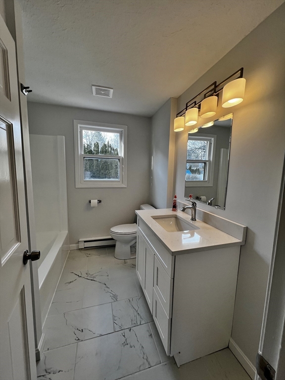 6 Mayfield Road Auburn, MA 01501 - Photo 29 of 30 a bathroom with a double vanity sink toilet and mirror