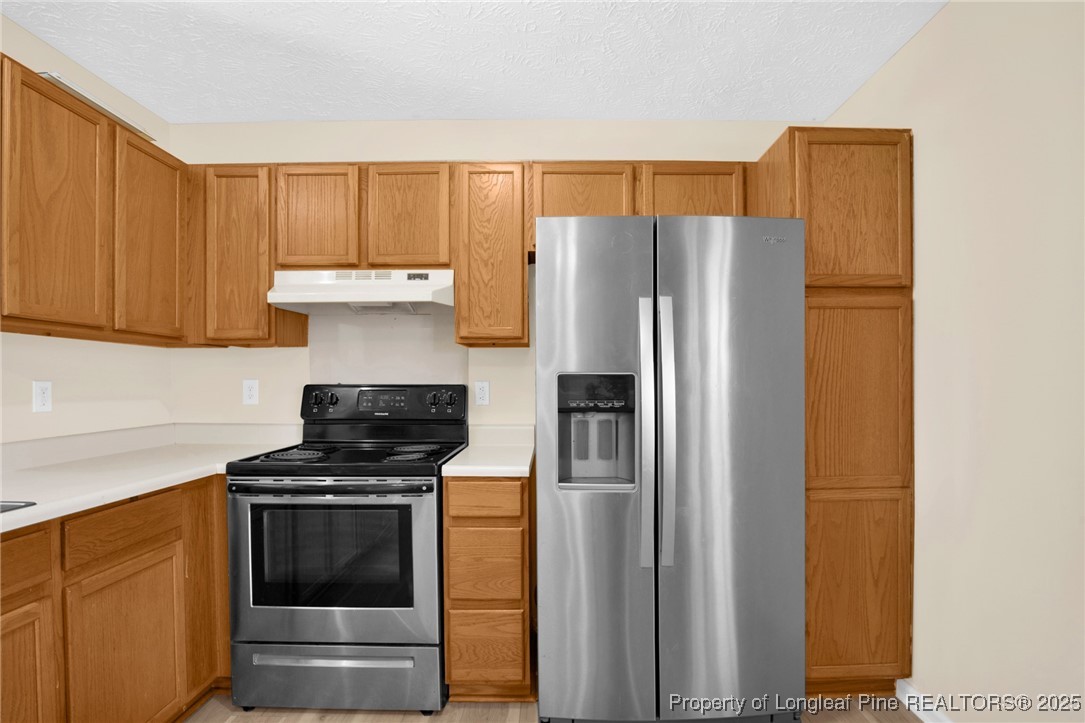 101 2 Hours Court Raeford, NC 28376 - Photo 12 of 30 a kitchen with stainless steel appliances a refrigerator and a stove top oven