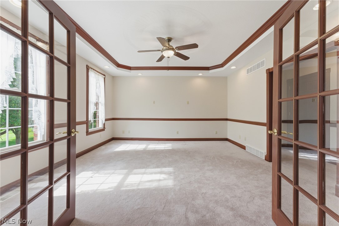 2184 Brenner Road Northeast Carrollton, OH 44615 - Photo 6 of 50 Spacious room featuring French doors with glass panes, tray ceiling, recessed lighting, and a ceiling fan