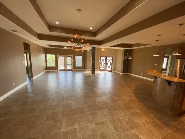 a view of an empty room with a chandelier