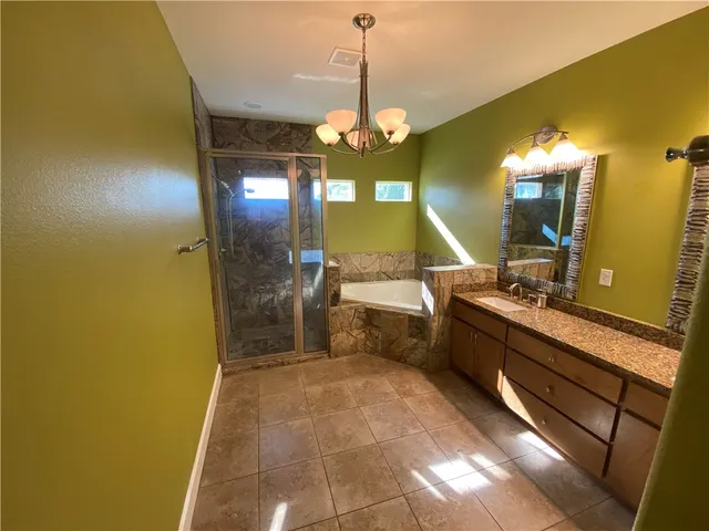 a bathroom with a sink a mirror and a shower