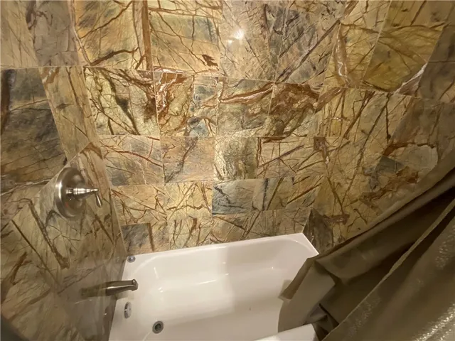 a bath tub sitting in a bathroom next to a sink