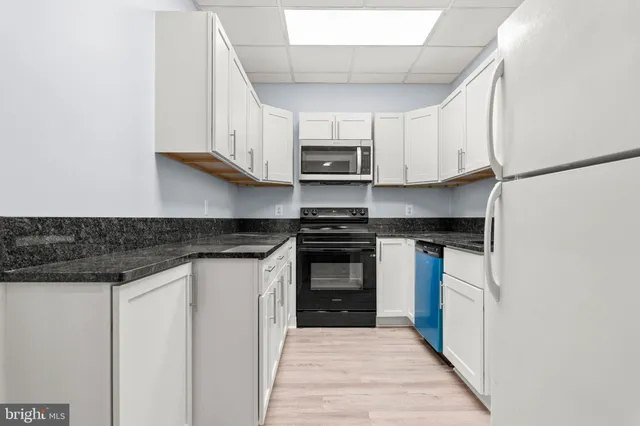 a kitchen with stainless steel appliances granite countertop a stove and a refrigerator