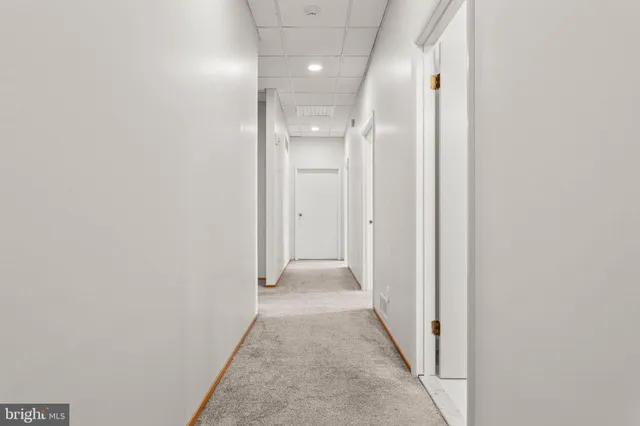 a view of a hallway with wooden shelves
