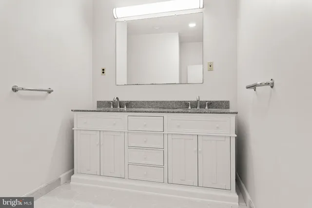a bathroom with a sink and mirror