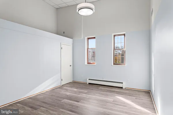 a view of a room with wooden floor and window