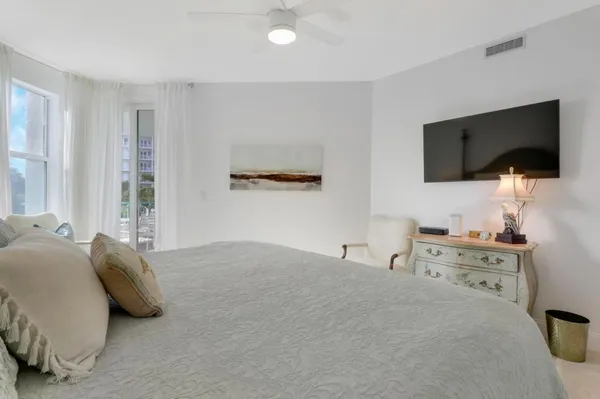 a bedroom with a bed and a night stand