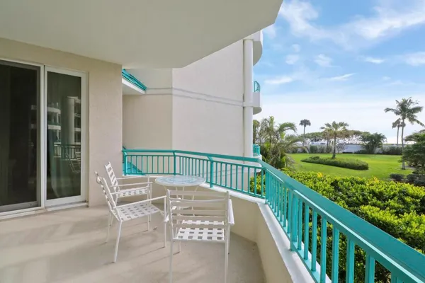 a view of a chair and table in the balcony