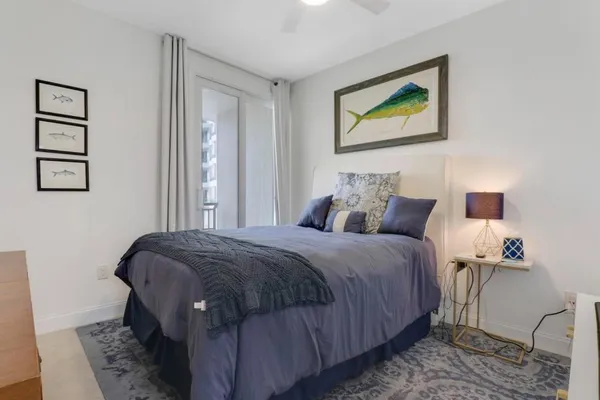 a bedroom with a bed and a painting on the wall