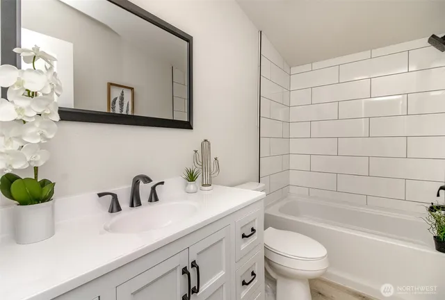 a bathroom with a sink a toilet and bathtub