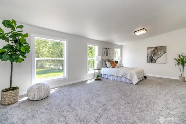 a bedroom with bed and a window