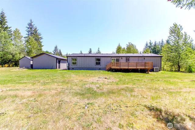 a view of a house with a yard and sitting area