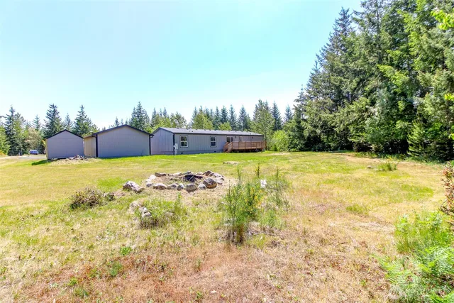a view of a swimming pool with an outdoor seating and a yard