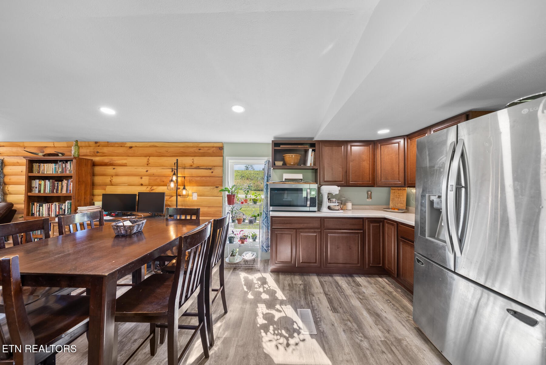 390 Sparkman Town Road Rock Island, TN 38581 - Photo 12 of 33 a kitchen with stainless steel appliances granite countertop a refrigerator a sink dishwasher a dining table and chairs with wooden floor