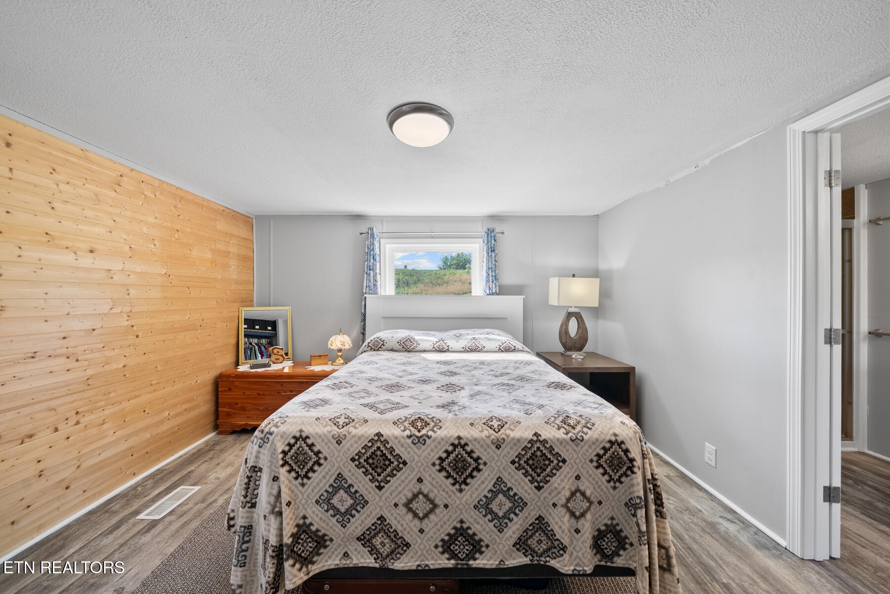 390 Sparkman Town Road Rock Island, TN 38581 - Photo 14 of 33 a bedroom with a bed and wooden floor