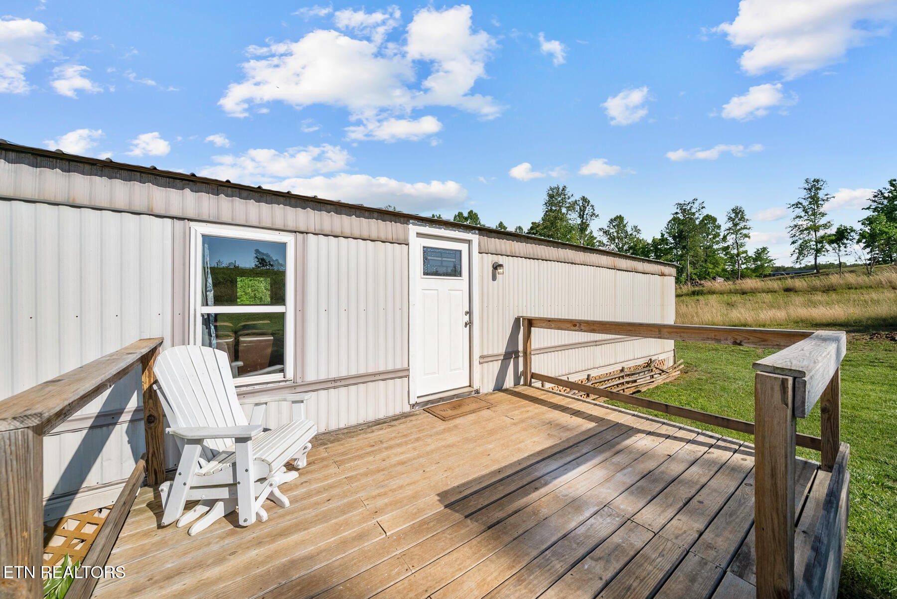 390 Sparkman Town Road Rock Island, TN 38581 - Photo 21 of 33 a roof deck with table and chairs and wooden floor