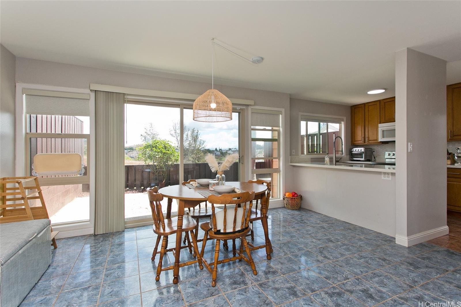Kitchen renovated to open up and create an eating counter with quartz countertops. All jalousies changed out to new quality vinyl windows. No popcorn ceilings. Ceramic tile floor downstairs for easy cleaning and maintenance.
