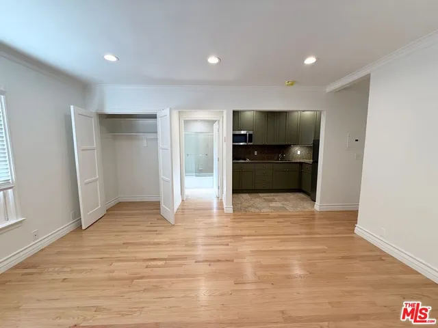 a view of empty room with wooden floor