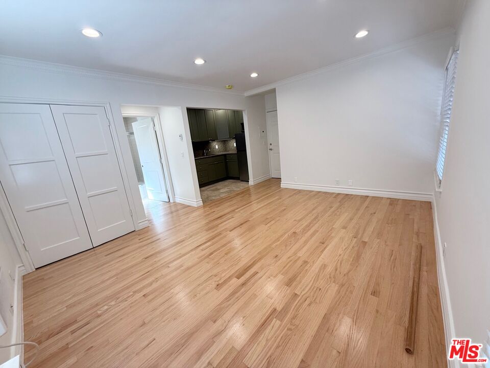 204 South Reeves Drive Beverly Hills, CA 90212 - Photo 5 of 10 a view of an empty room with wooden floor