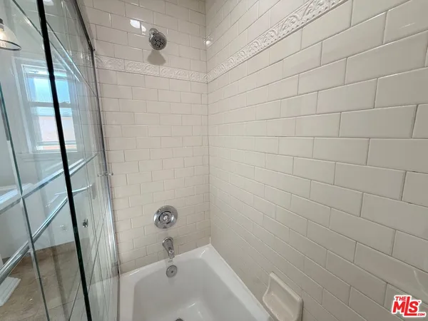 a bathroom with a shower and a sink