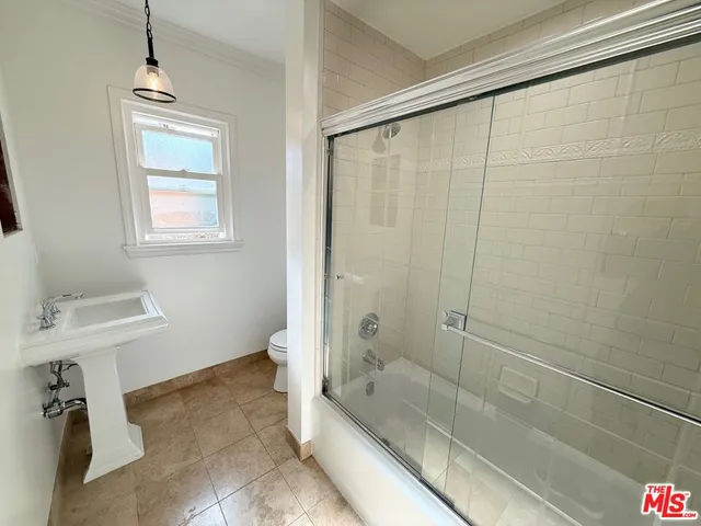 a kitchen with a refrigerator and a sink