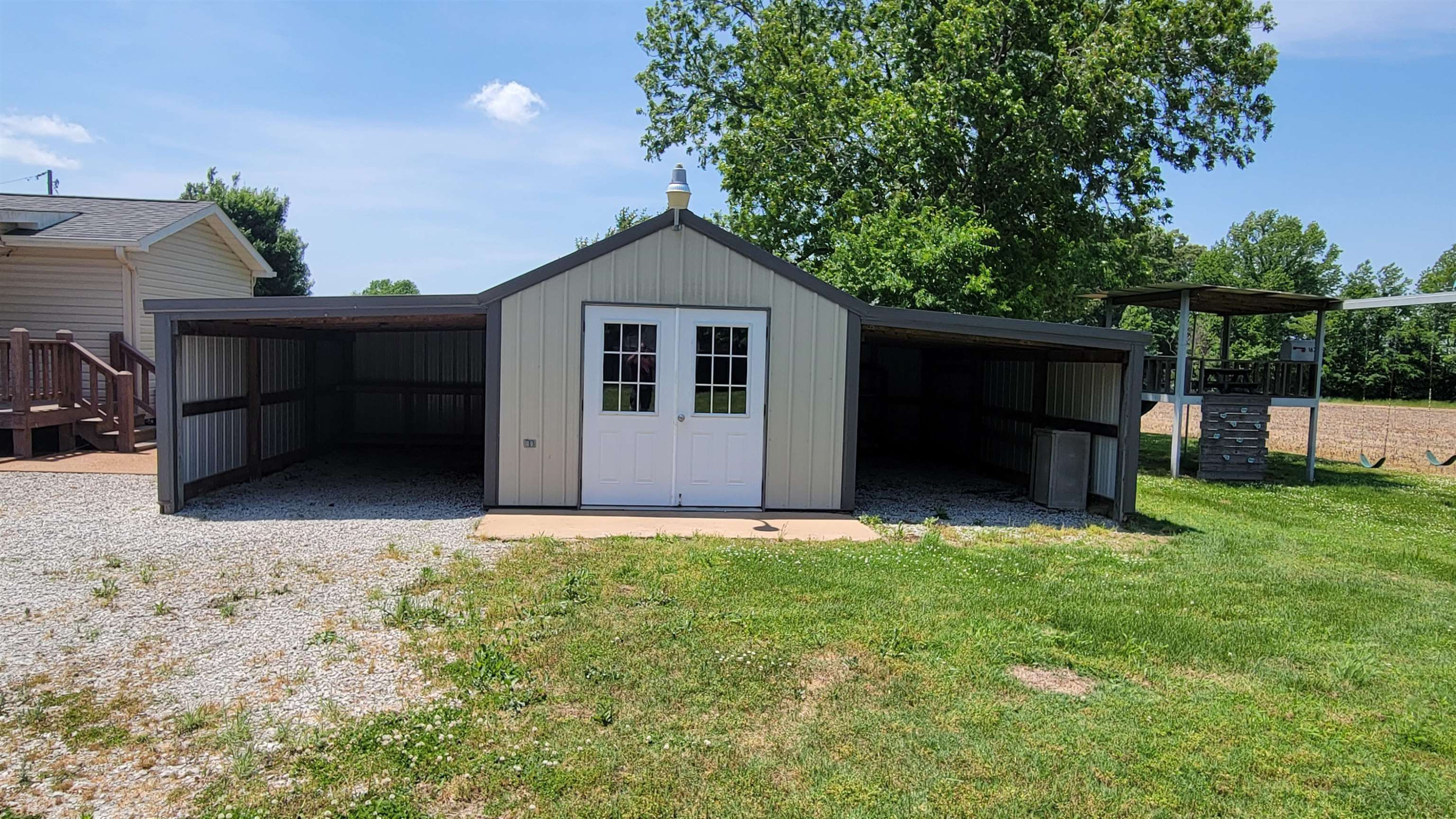 183 Spring Creek Law Road Jackson, TN 38305 - Photo 15 of 42 a view of backyard with flat screen tv and a large tree