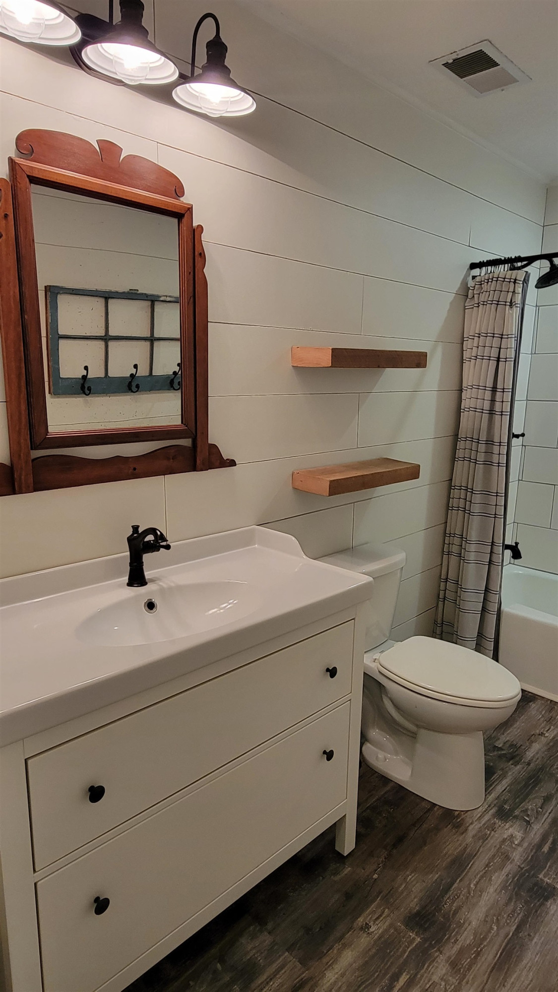 183 Spring Creek Law Road Jackson, TN 38305 - Photo 21 of 42 a bathroom with a toilet a sink and mirror