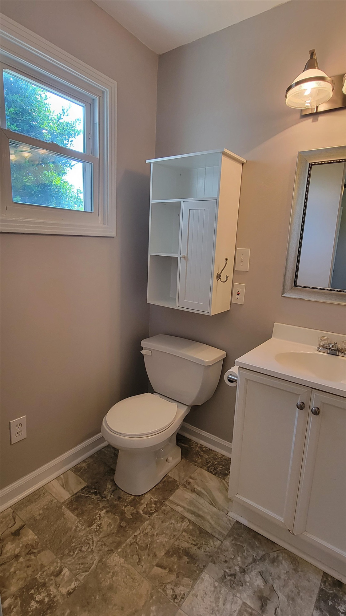 183 Spring Creek Law Road Jackson, TN 38305 - Photo 26 of 42 a bathroom with a toilet a sink and mirror
