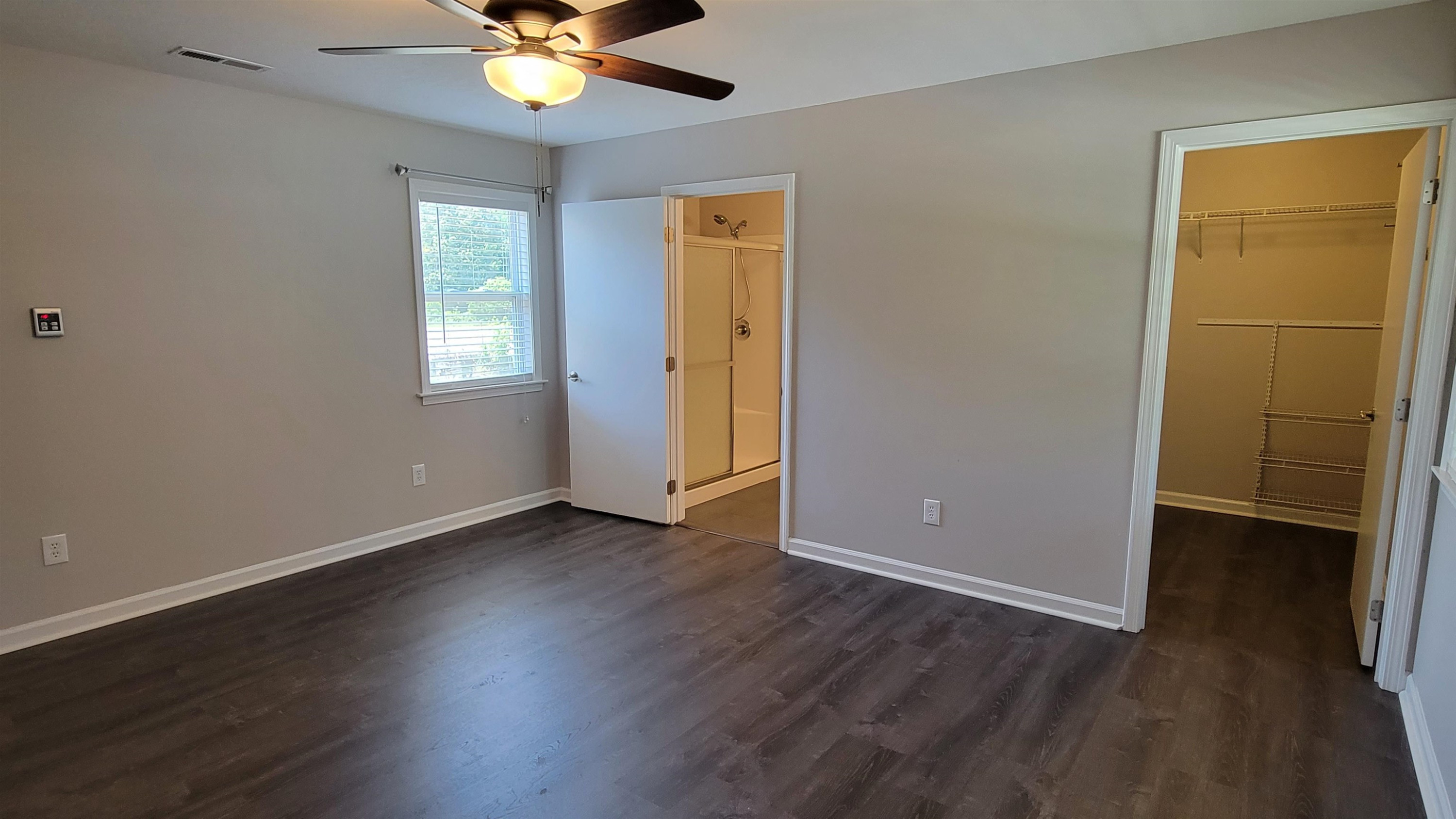 183 Spring Creek Law Road Jackson, TN 38305 - Photo 31 of 42 a view of an empty room with window and wooden floor
