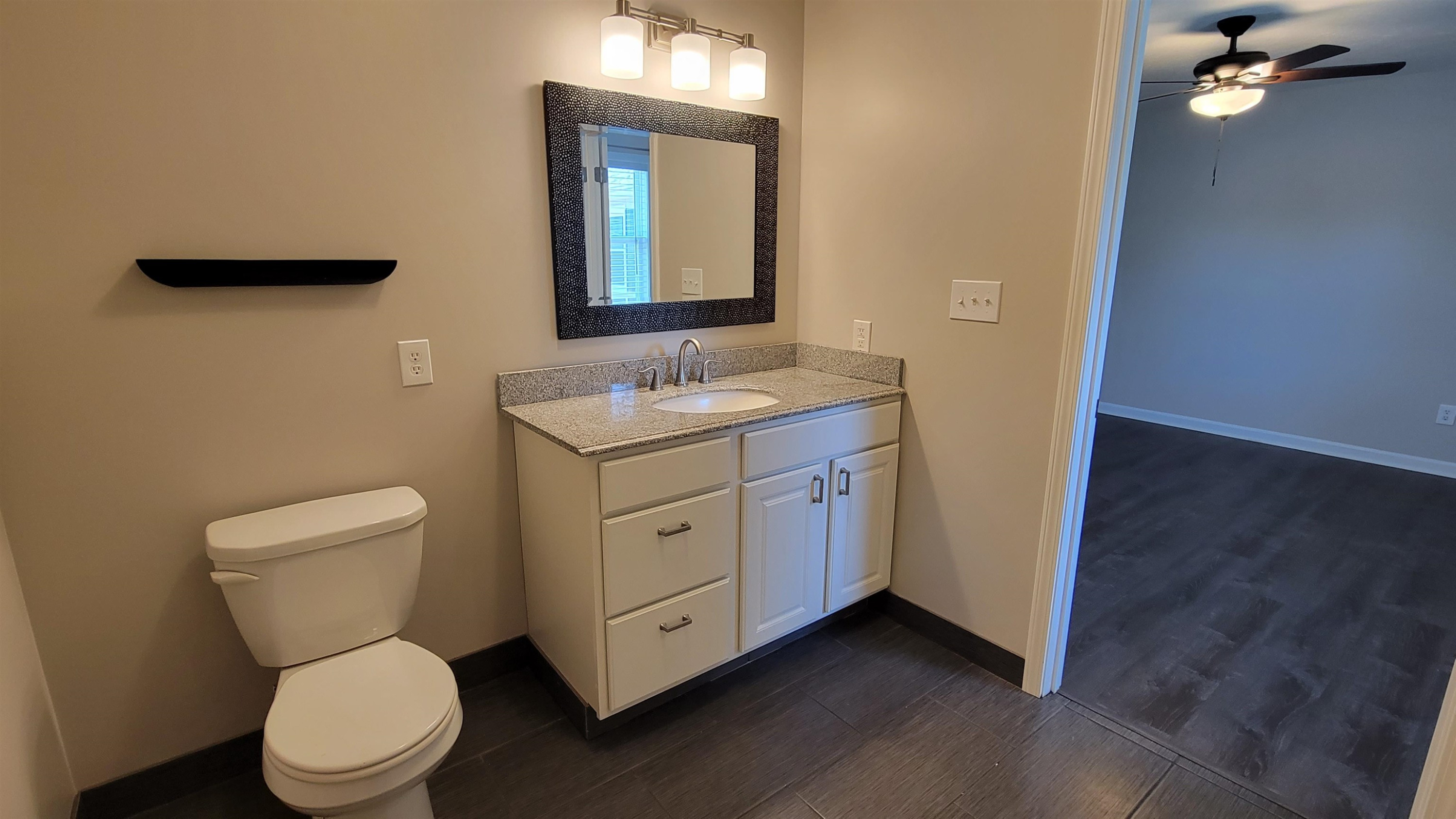183 Spring Creek Law Road Jackson, TN 38305 - Photo 34 of 42 a bathroom with a toilet a sink and mirror