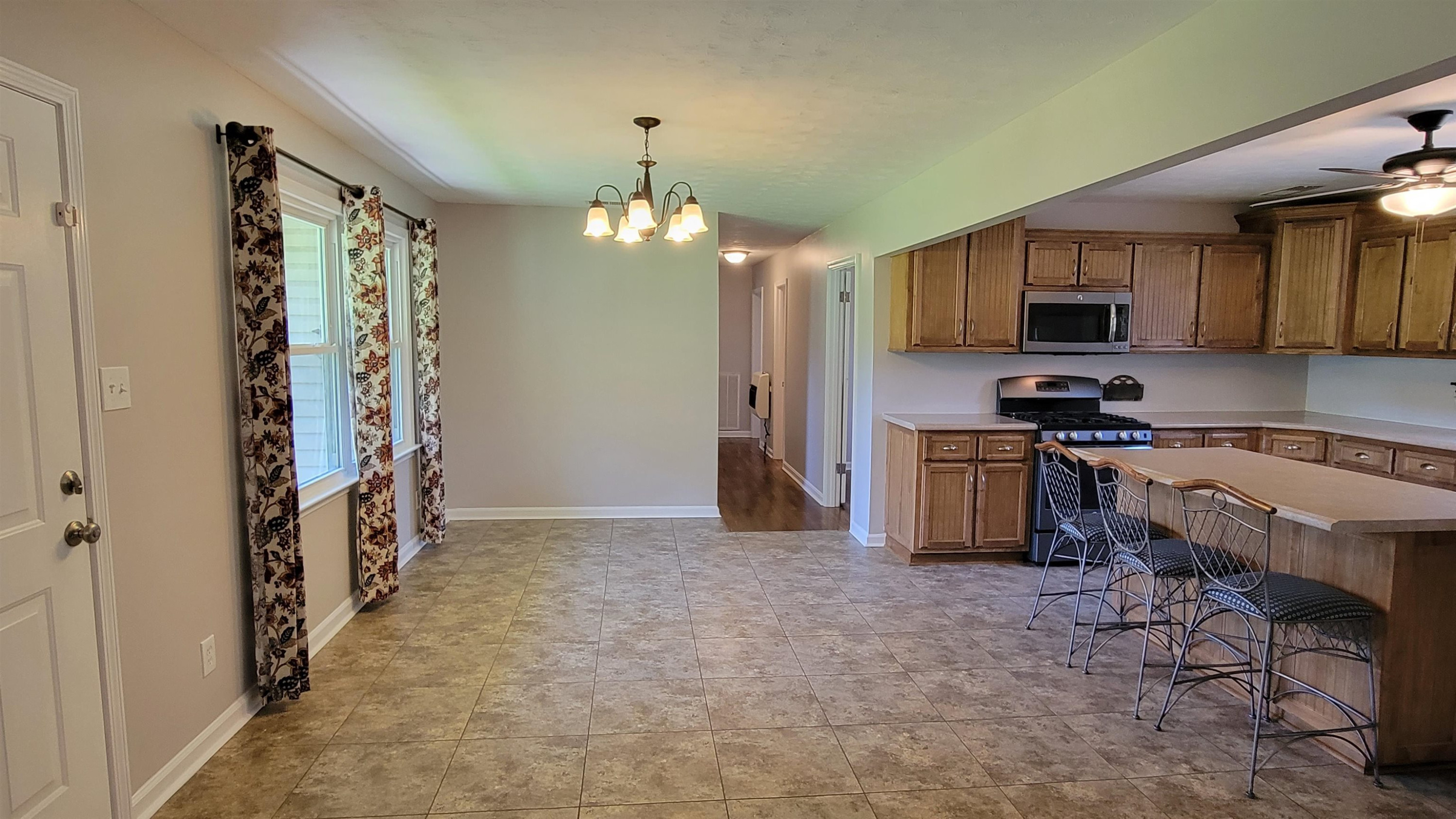 183 Spring Creek Law Road Jackson, TN 38305 - Photo 10 of 42 a kitchen that has a lot of cabinets and wooden floor