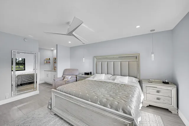 a bedroom with a bed and a mirror