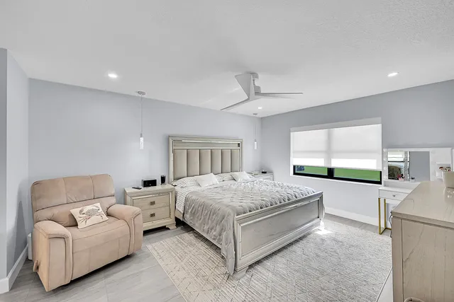 a spacious bedroom with a bed and window