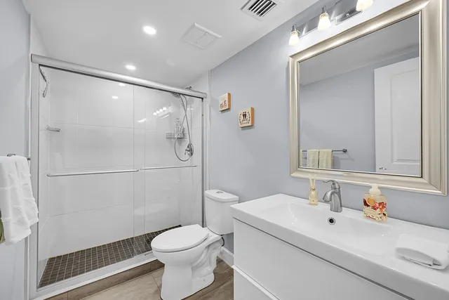 a bathroom with a sink toilet and shower