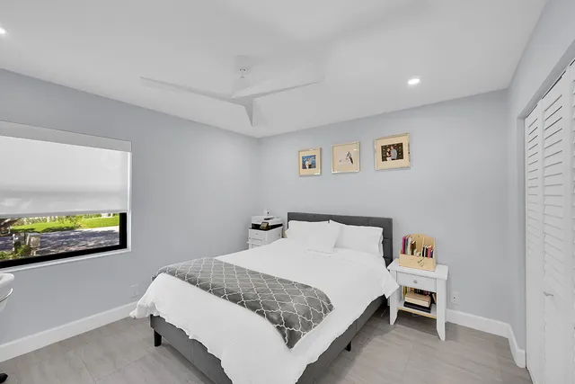 a bedroom with a bed and a painting on the wall