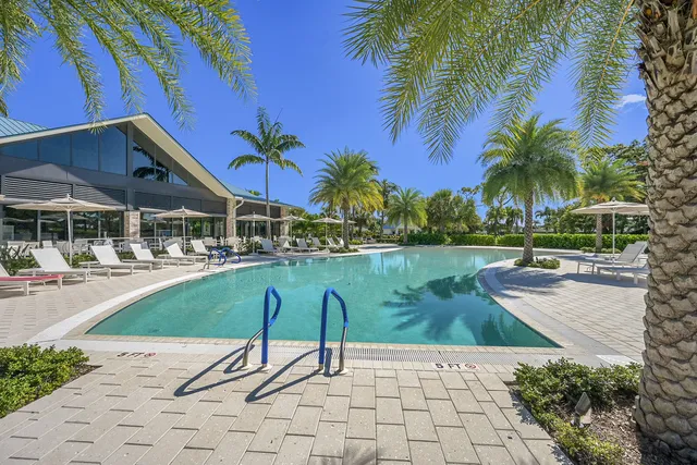 a swimming pool with outdoor seating and yard
