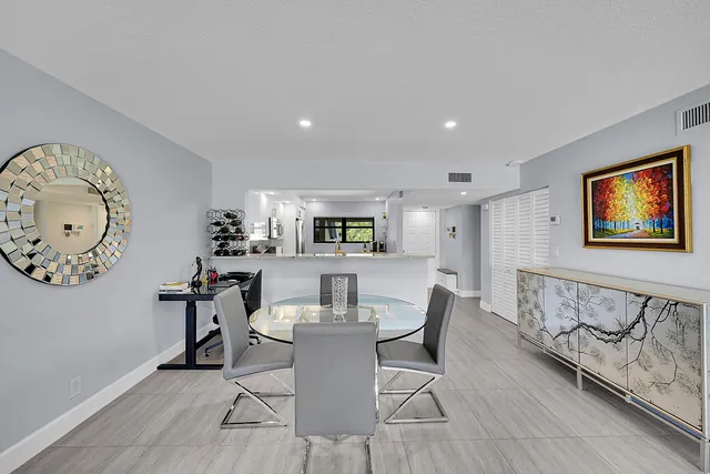 a view of a dining room with furniture a rug and wooden floor