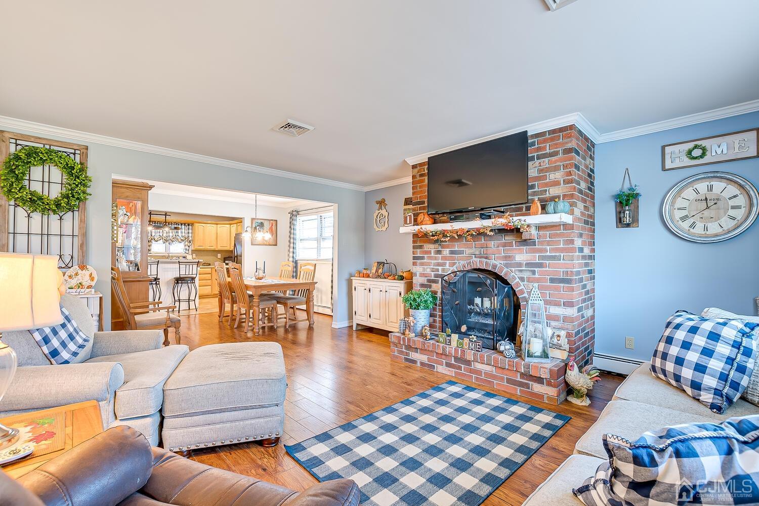 50 Old Post Road Edison, NJ 08817 - Photo 11 of 39 a living room with furniture a flat screen tv and a fireplace