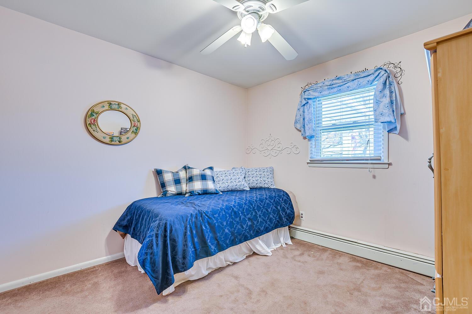 50 Old Post Road Edison, NJ 08817 - Photo 24 of 39 a bedroom with a bed and a chandelier
