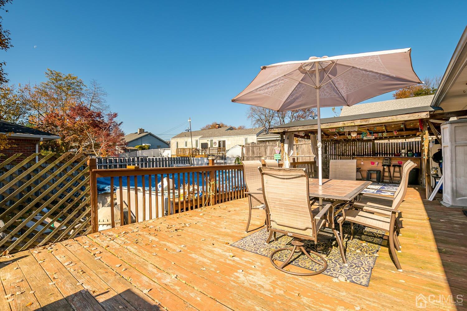 50 Old Post Road Edison, NJ 08817 - Photo 32 of 39 a view of a patio with a table and chairs under an umbrella