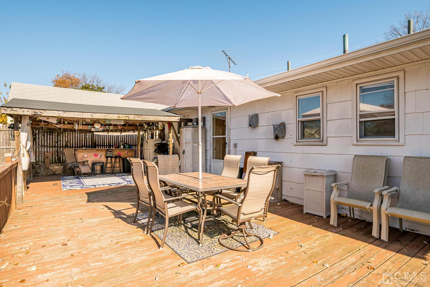 50 Old Post Road Edison, NJ 08817 - Photo 34 of 39 a view of a patio with table and chairs under an umbrella