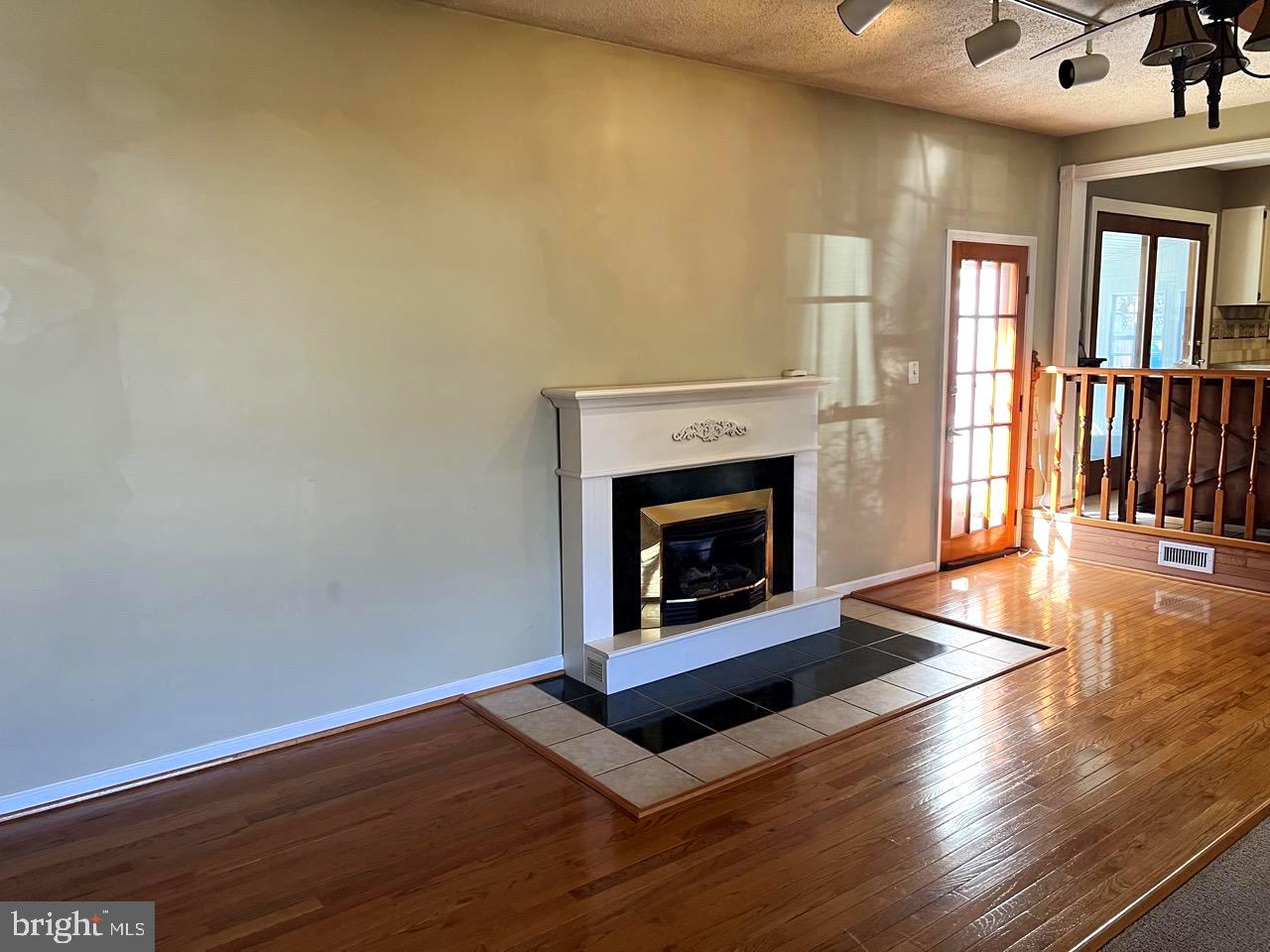 3502 Old Jones Road Dunkirk, MD 20754 - Photo 15 of 61 a living room with wooden floor and a fireplace