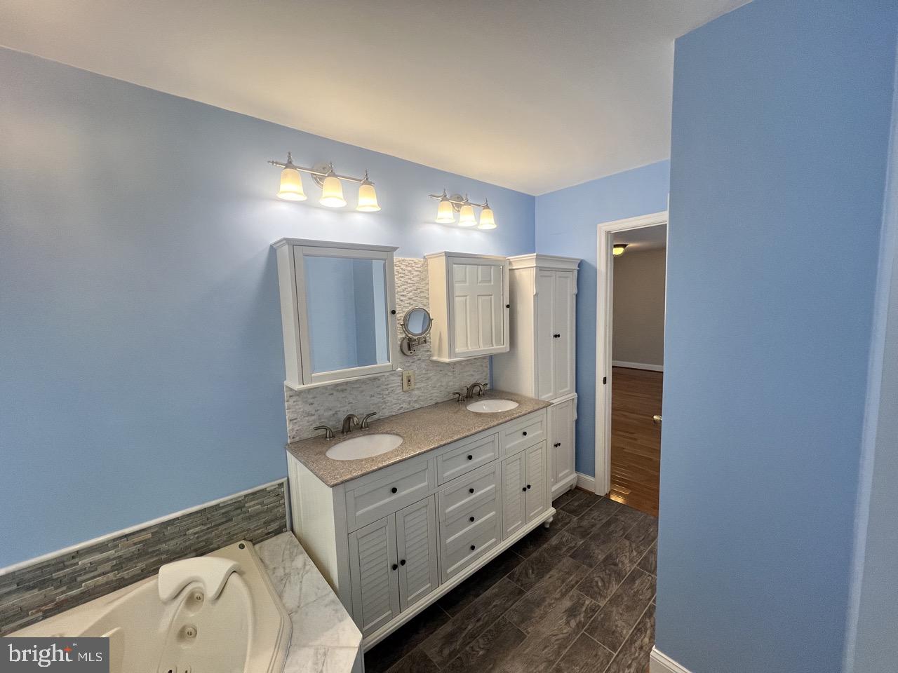 3502 Old Jones Road Dunkirk, MD 20754 - Photo 26 of 61 a bathroom with a granite countertop sink mirror and shower