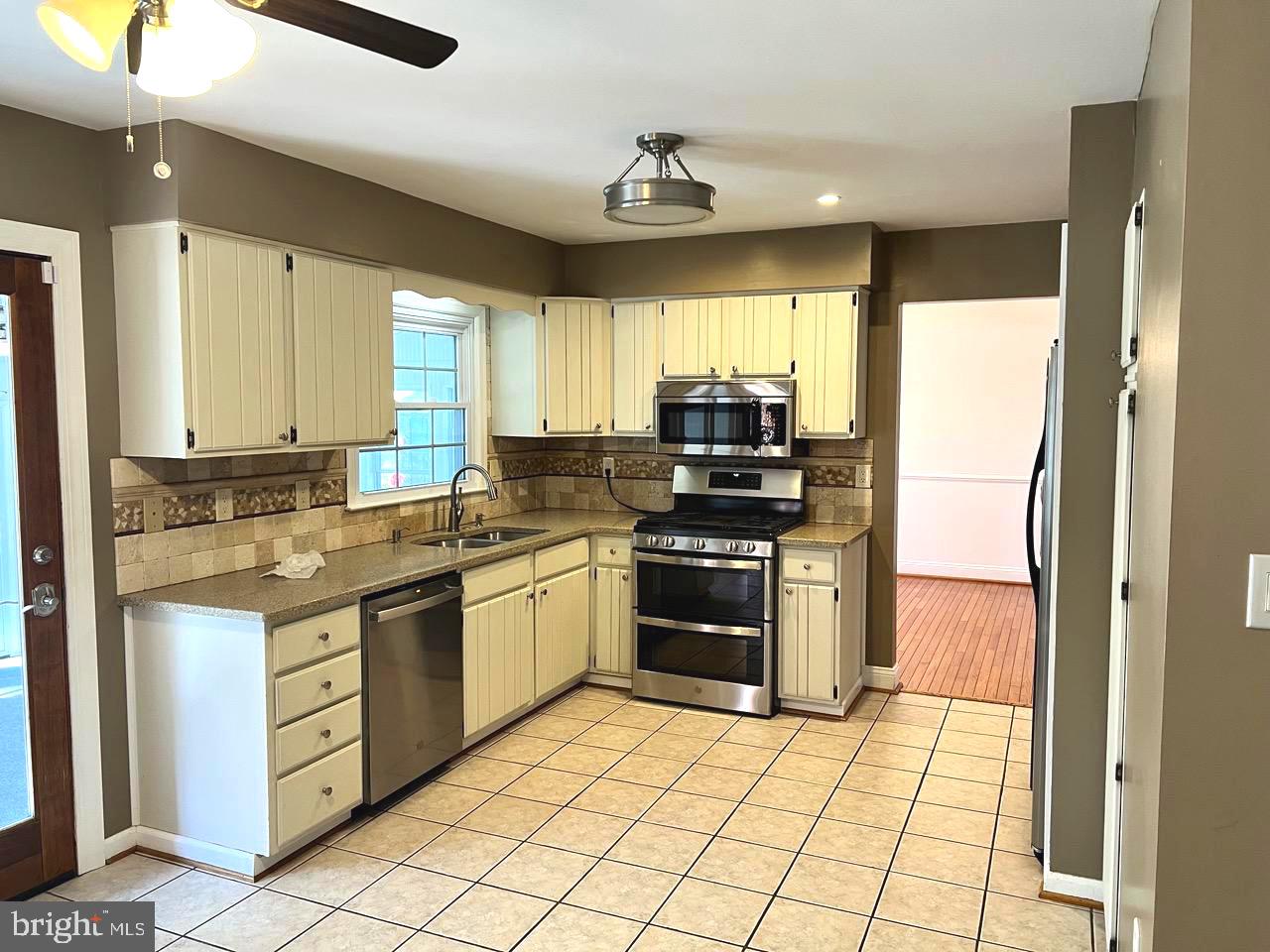 3502 Old Jones Road Dunkirk, MD 20754 - Photo 9 of 61 a kitchen with stainless steel appliances granite countertop a refrigerator and a stove top oven